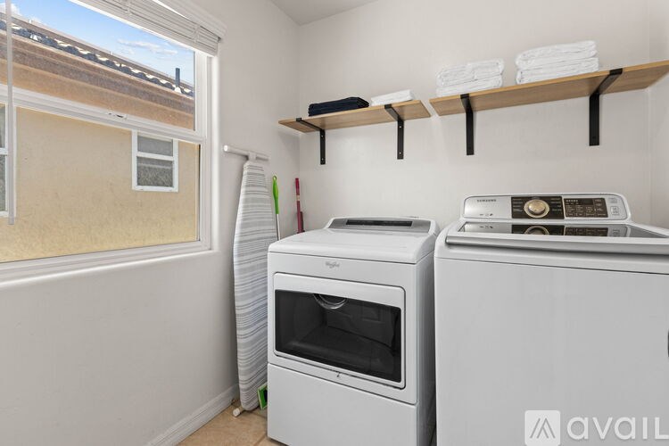 A kitchen with a white oven and a white microwave.