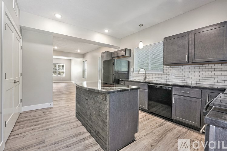 A kitchen with a wooden island and stainless steel appliances.