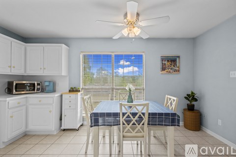 A dining room with a table set for four.