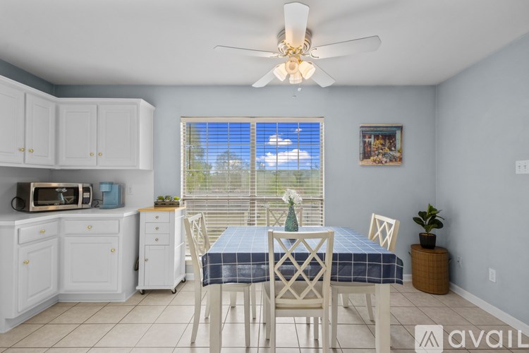 A dining room with a table set for four.