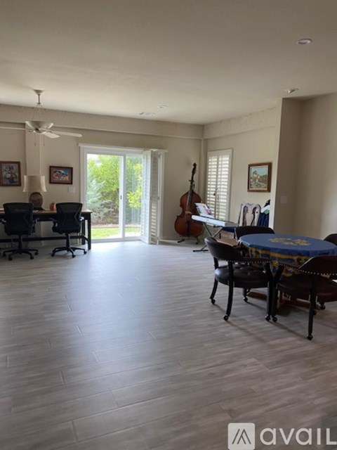 A living room with a dining table and chairs.