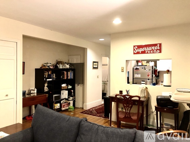 A living room with a couch and a bookshelf.