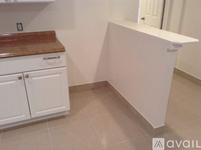 A kitchen with white cabinets and a counter.