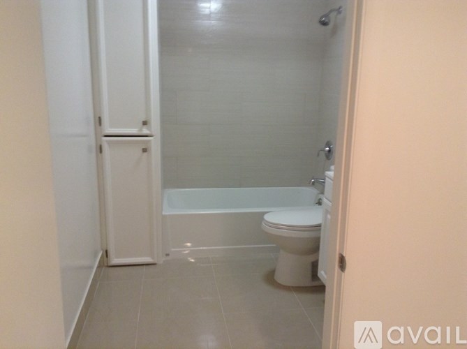 A small bathroom with a toilet and a bathtub.