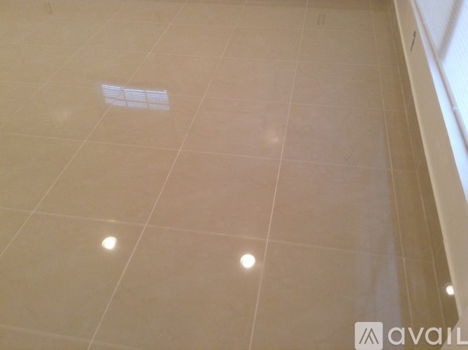 A tiled floor with a small square tile missing in the middle.