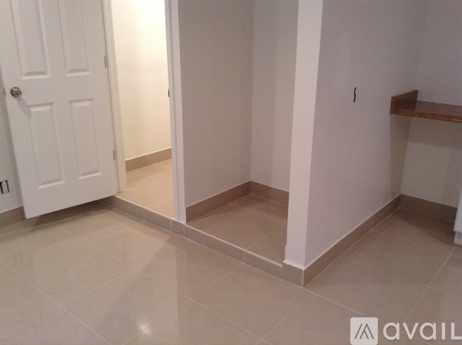 A white door is on the left and a white wall is on the right.