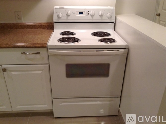 A white stove with a white oven in a kitchen.