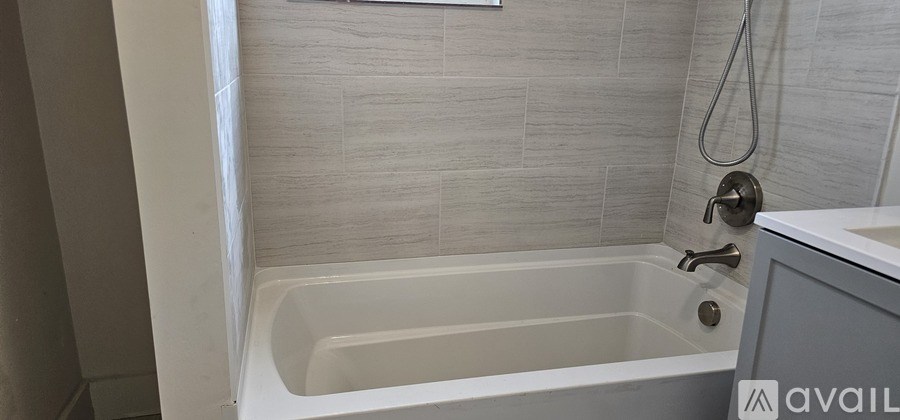 A tan station wagon is parked on a driveway.