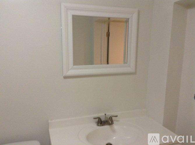 A bathroom with a sink and mirror.