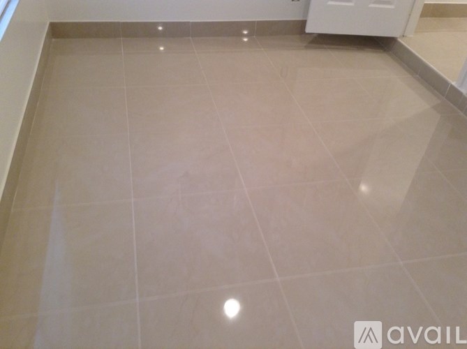 A tiled floor in a room with a white cabinet.