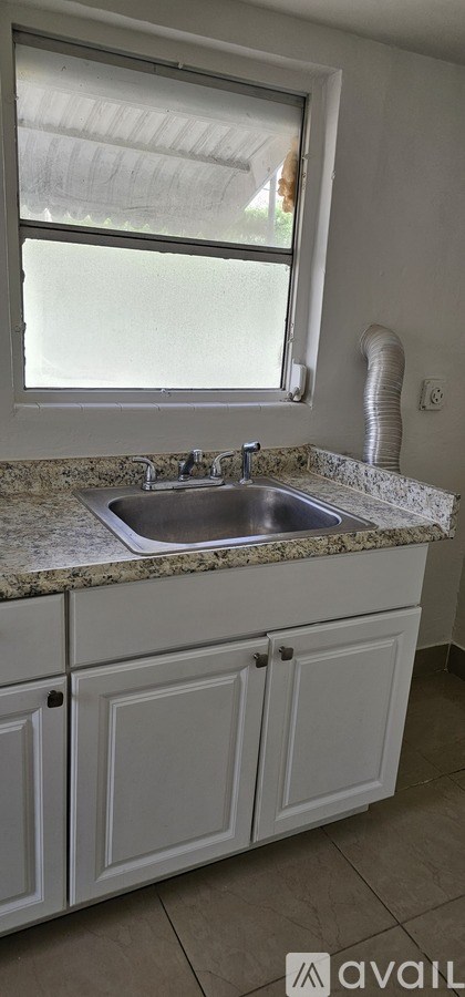 A black framed mirror on a white wall.