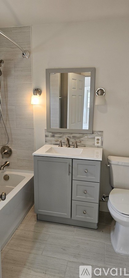 A room with a white door and a window with blinds.