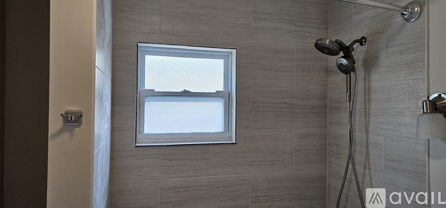 A white toilet in a small bathroom with a wooden cabinet.