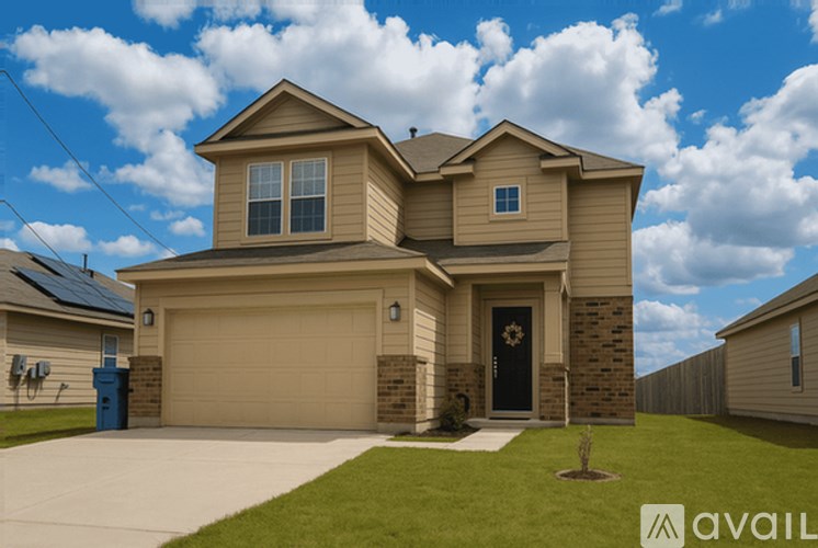 A house with a garage and a driveway in front.