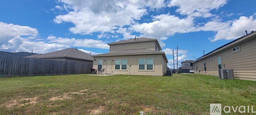 A house with a fence and a grassy yard is available for sale.