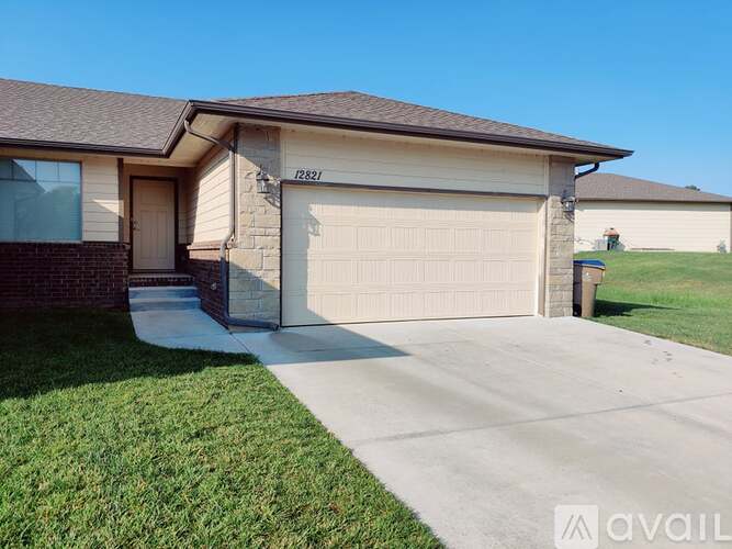 A house with the number 12821 on the front wall and a garage door.