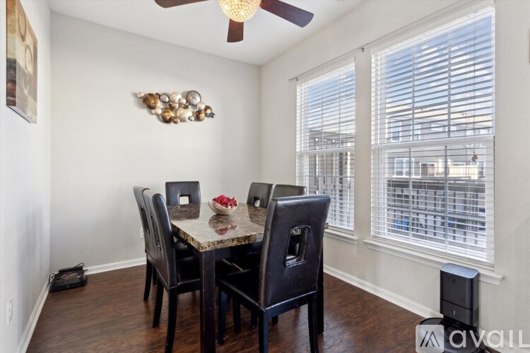 A dining room with a table and chairs.