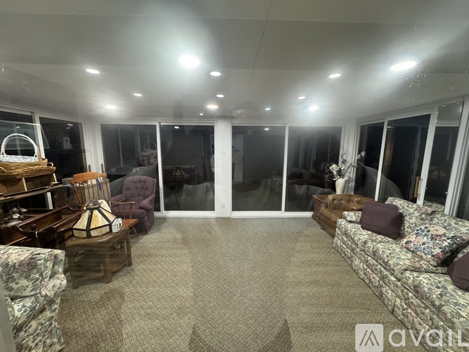 A living room with a couch, chairs, and a coffee table.