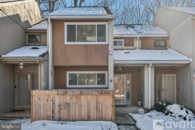 A house with a brown facade is for sale.