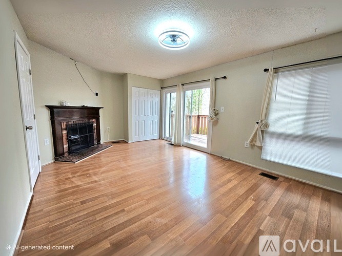 A living room with a fireplace and sliding glass doors.