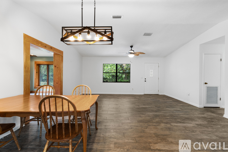 A dining room with a wooden table and chairs.