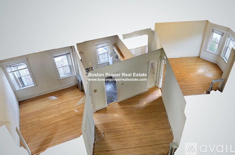 A top-down view of a room with wooden floors and white walls.