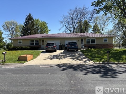 A house with a garage and a driveway in front of it.