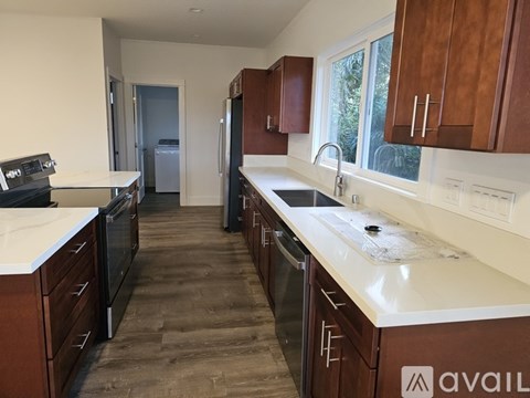 A kitchen with brown cabinets and a white counter top.
