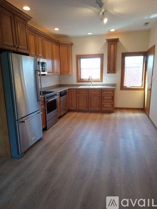 A kitchen with wooden cabinets and a blue stove.