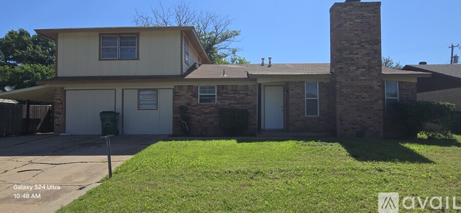 A house with a garage and a chimney is for sale.