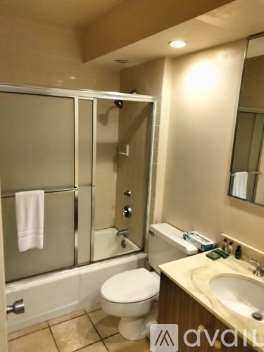 A bathroom with a toilet, sink, and shower.