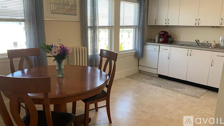A dining room with a wooden table and chairs.
