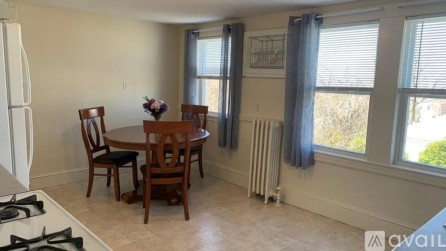 A kitchen with a table and chairs by the window.