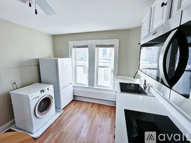 A small kitchen with a washer and dryer.