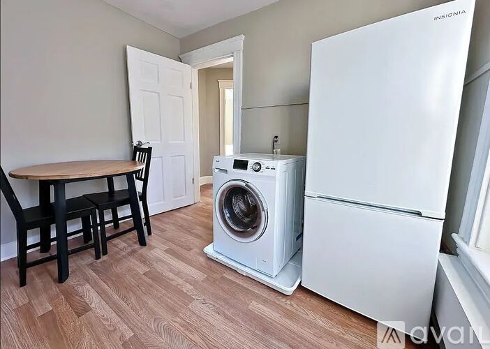 A small laundry room with a washer and dryer.