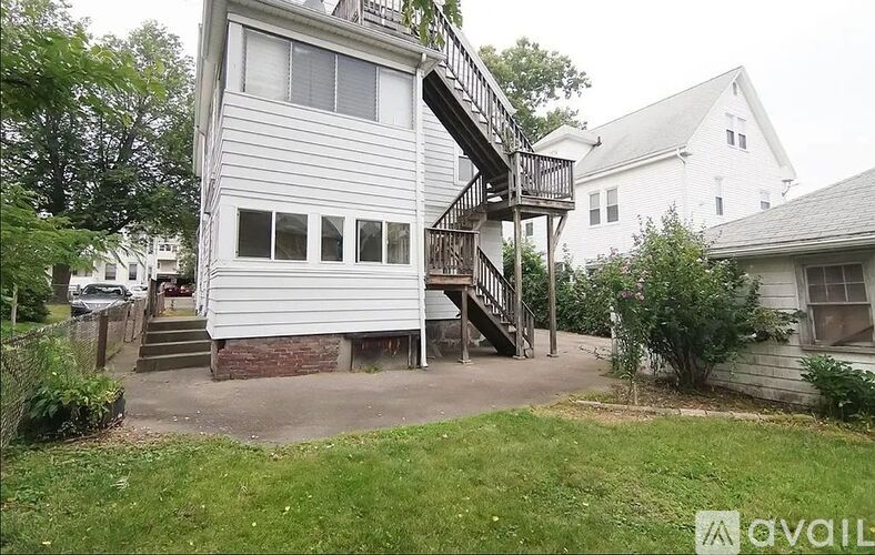 A house with a white exterior and a deck with a railing.