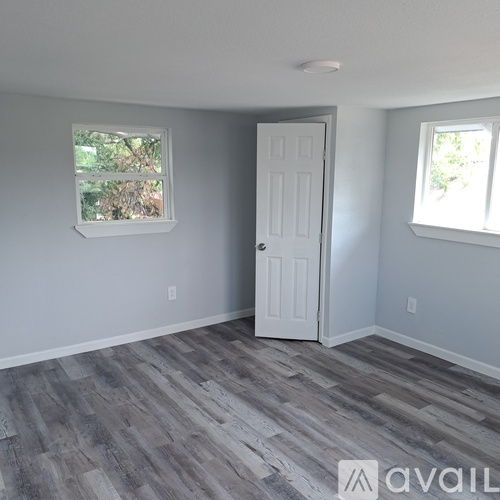A room with a white door and a window with a white frame.