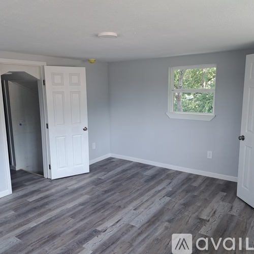 A room with a grey floor and white walls.