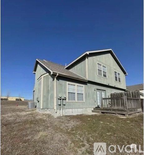 A house with a grey exterior and a brown fence.