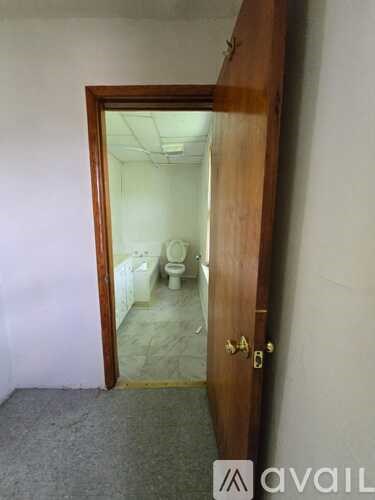A bathroom is visible through a doorway.