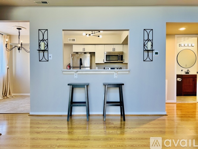 Two bar stools are placed in front of a kitchen island.