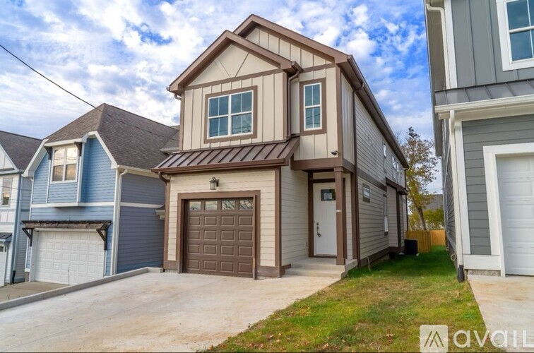 A house with a brown garage door is for sale.