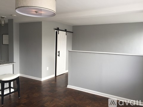 A room with a sliding door and a bar stool.