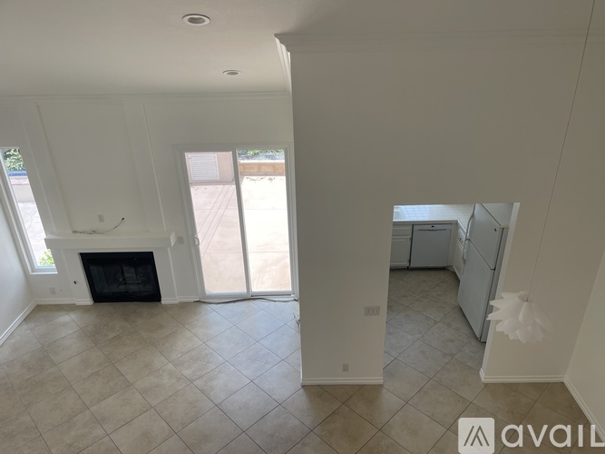 A spacious living room with a fireplace and sliding glass doors.