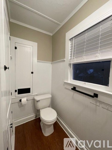 A small white toilet in a small bathroom.