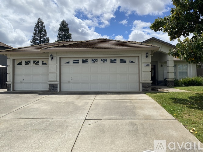 A house with a white garage door is for sale.