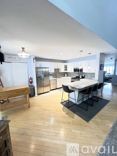A modern kitchen with a dining table and chairs.