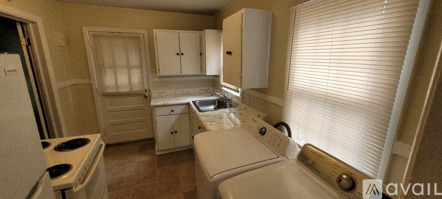 A small kitchen with a washer and dryer.