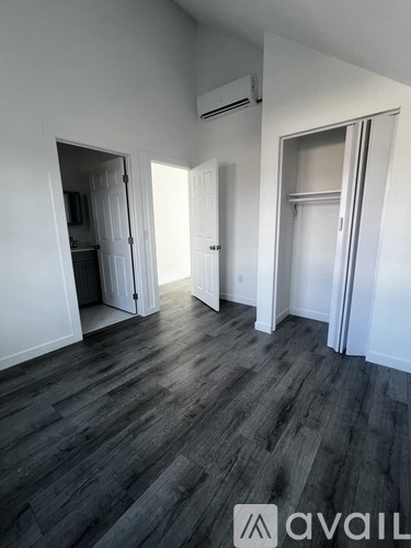 A room with wooden floors and white walls.
