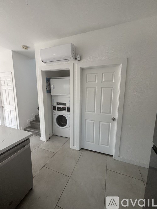 A small laundry room with a washing machine and dryer.